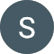A dark gray circle with the letter 'S' in white at the center, reminiscent of an auto body's sleek emblem, set against a dark background.